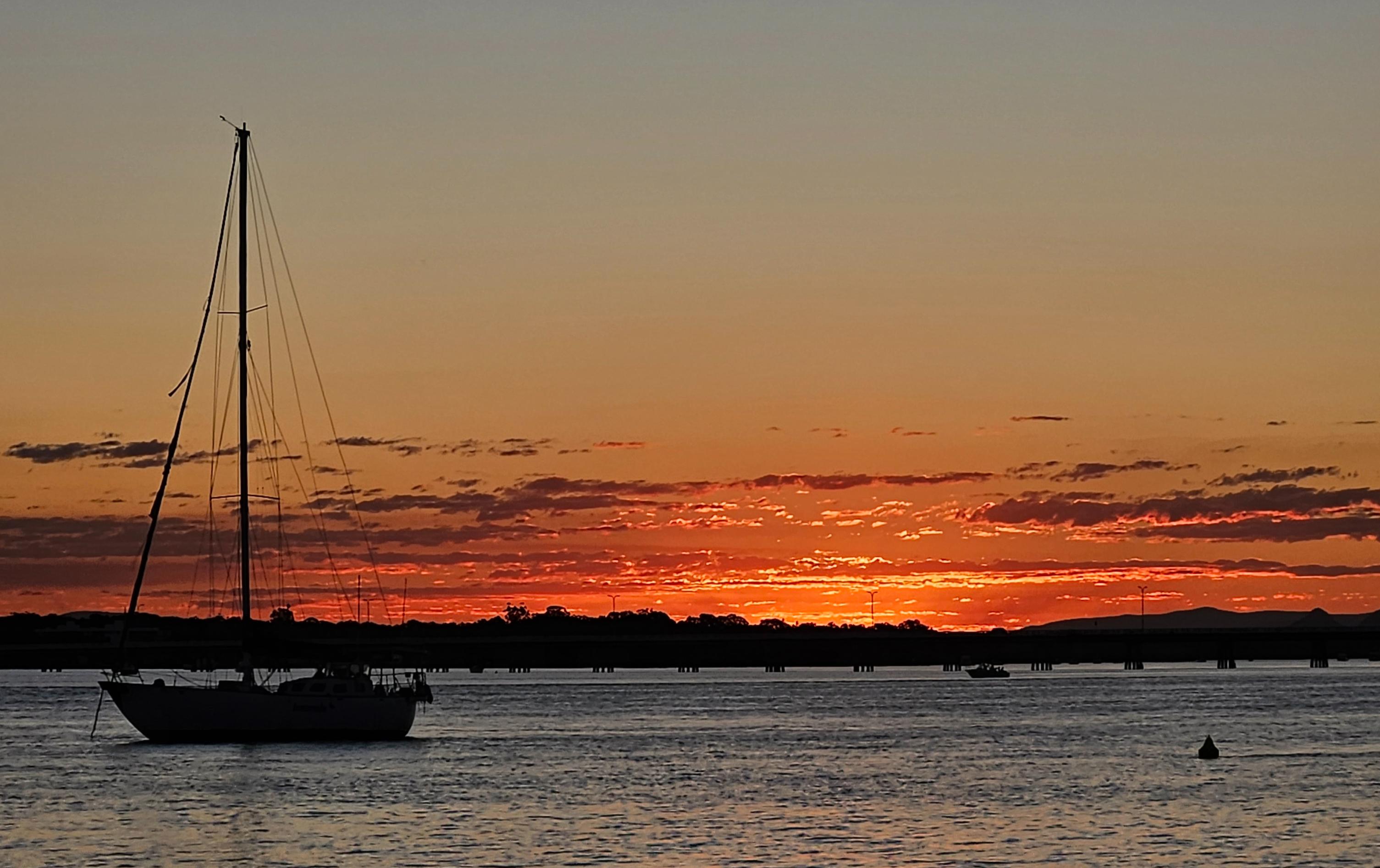 Sailboat silhouette at sunset Pumicestone Passage